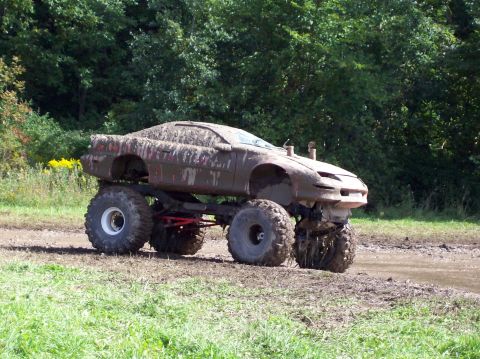 1979 Ford Bronco - This heavily modified vehicle is built for off-road mud bogging, with a car body mounted on a lifted truck chassis.