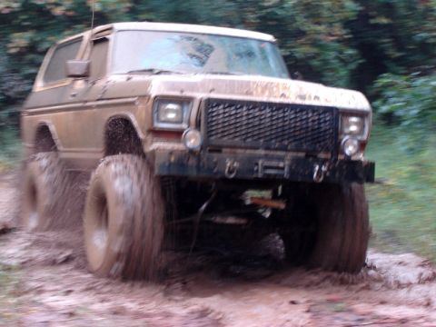1992 Ford Mustang - This lifted 1978 Ford Bronco is navigating a challenging muddy terrain.