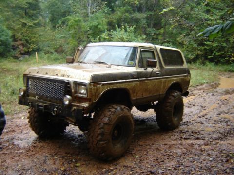 1992 Ford Mustang - This lifted Ford Bronco is ready for off-road adventure on a muddy trail.