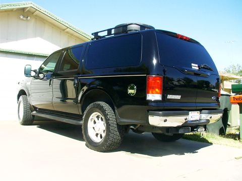 2000 Ford Excursion - Rear view of a black Ford Excursion SUV, parked in front of a building.
