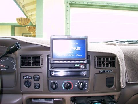 2000 Ford Excursion - The interior of a 2000 Ford Excursion displays its dashboard, an aftermarket stereo and navigation system.