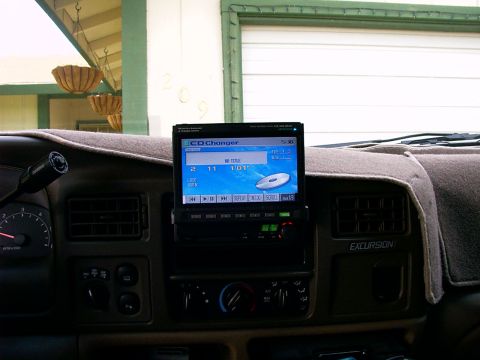 2000 Ford Excursion - Interior view of a 2000 Ford Excursion dashboard, an aftermarket screen displaying CD changer information.