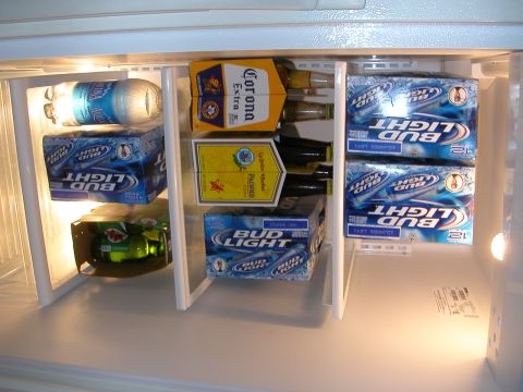 1984 Ford Bronco - Stocked refrigerator with various beverages including Bud Light and Corona beer.