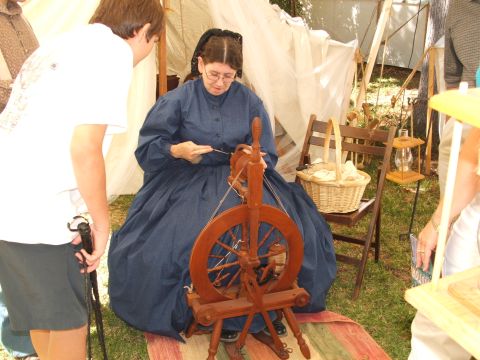 1966 Ford Ranchero - A historical reenactment shows a woman demonstrating wool spinning with a wooden wheel.