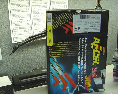 1986 Ford Bronco - A boxed set of Accel 300+ Ferro-Spiral race ignition wires standing on a desk, with red plug boots and wires visible poking out of the top…