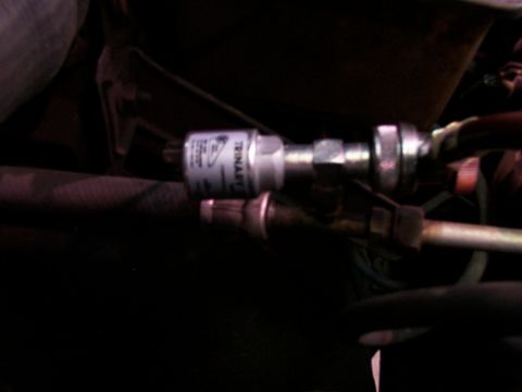 1988 Ford C-350 (Centurion Conversions) - A close-up view of an air conditioning component, identified as TRINAFLEX, is visible within the vehicle's engine bay.