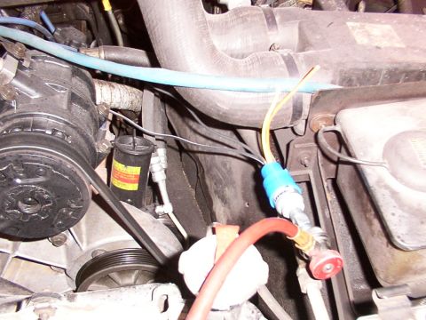 1988 Ford C-350 (Centurion Conversions) - Detail of vehicle's air conditioning system, showing compressor, hoses, and gauges.