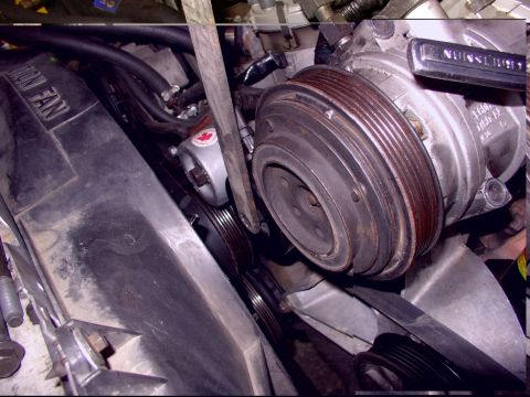 1988 Ford C-350 (Centurion Conversions) - Close-up view of an engine bay, focusing on the air conditioning compressor and fan assembly. Text 'UNION FAN' is visible on a shroud.