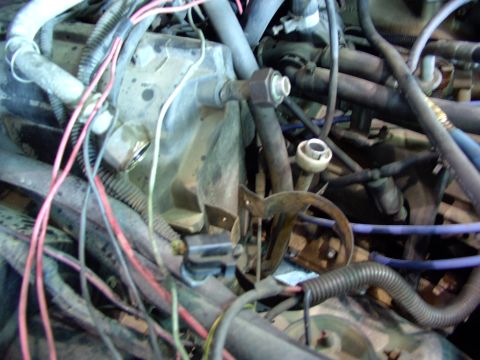 1988 Ford C-350 (Centurion Conversions) - A close-up view of the complex wiring and plumbing within a vehicle's engine compartment.