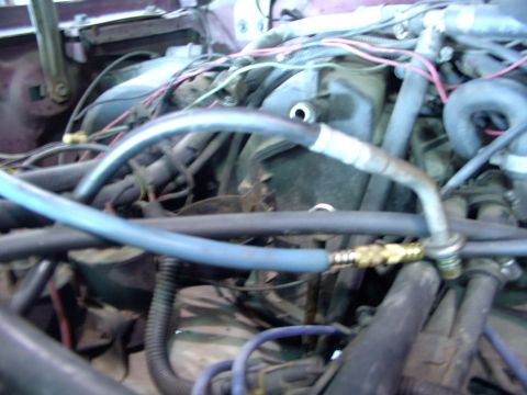 1988 Ford C-350 (Centurion Conversions) - Close-up view of the engine bay, focusing on the air conditioning system components and associated wiring.