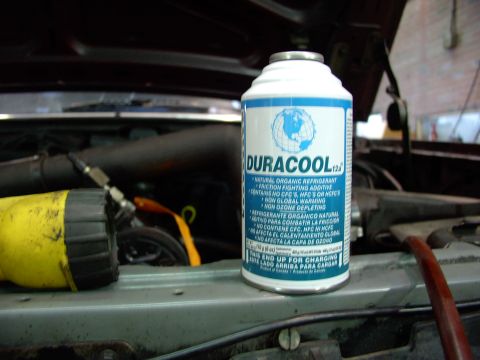 1988 Ford C-350 (Centurion Conversions) - A can of Duracool refrigerant sits in the engine bay next to a yellow tool, likely for air conditioning service.