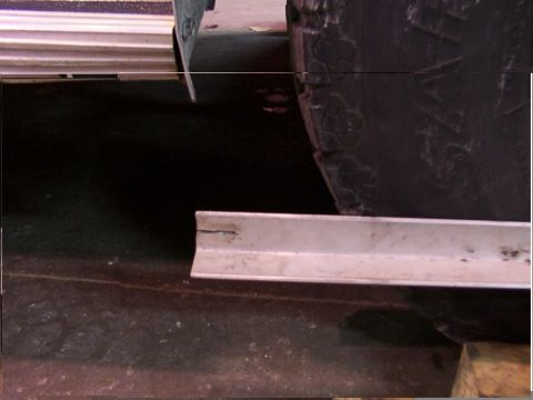 1988 Ford C-350 (Centurion Conversions) - Detail shot of a tire and a metal bracket, likely part of a larger assembly.