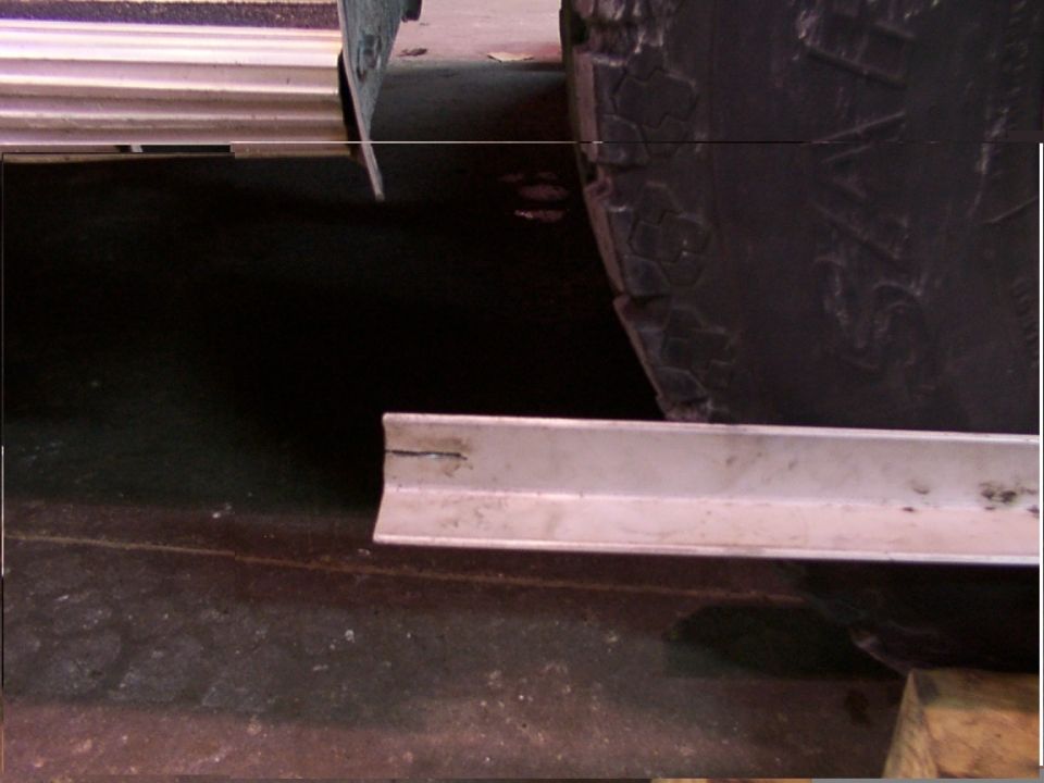 Close-up of a tire and a metal angle bracket