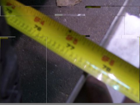 1988 Ford C-350 (Centurion Conversions) - A close-up of a yellow measuring tape with visible markings and numbers.