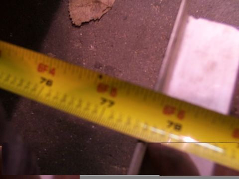1988 Ford C-350 (Centurion Conversions) - A close-up of a yellow measuring tape shows markings for feet and inches, indicating measurements.