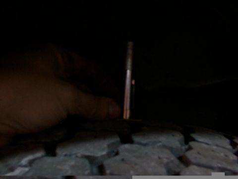 1988 Ford C-350 (Centurion Conversions) - A tire tread depth gauge is used to measure the wear on a tire.