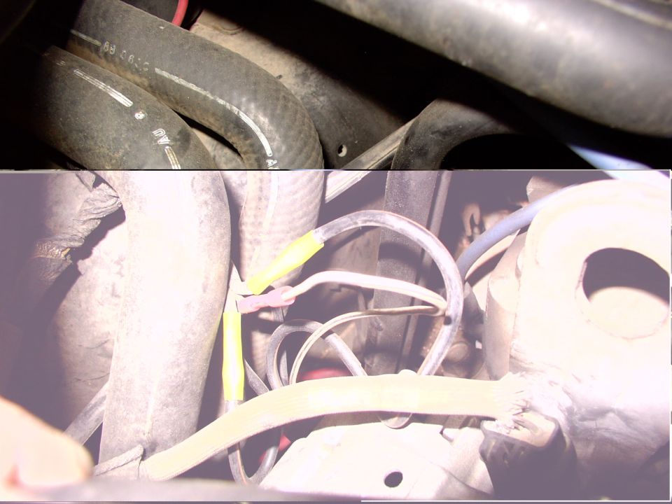 Engine bay showing hoses and electrical wiring with yellow tape on connectors