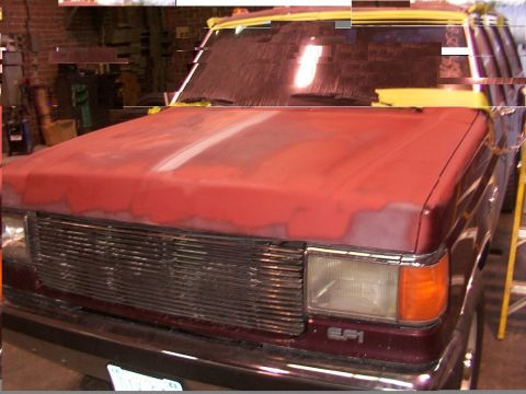 1988 Ford C-350 (Centurion Conversions) - This Ford F-Series truck's hood is prepped for paint, showing a transition from maroon to red primer.