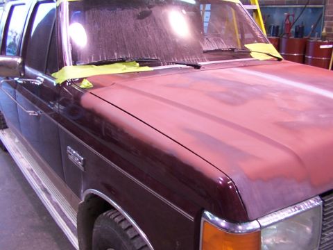 1988 Ford C-350 (Centurion Conversions) - The hood of a maroon 1988 Ford C-350 (Centurion Conversions) is shown prepped for paintwork.