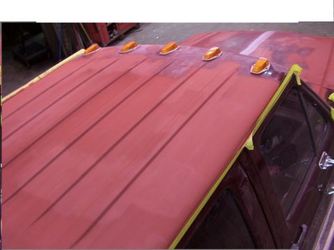 1988 Ford C-350 (Centurion Conversions) - The red primer on the truck's roof is taped off, ready for a new paint job. Amber clearance lights are visible.