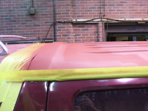 1988 Ford C-350 (Centurion Conversions) - A vehicle's roof is masked and primed for painting, with another vehicle partially visible.