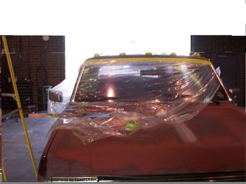 1988 Ford C-350 (Centurion Conversions) - Truck cab covered in plastic sheeting, possibly in a workshop or garage setting.