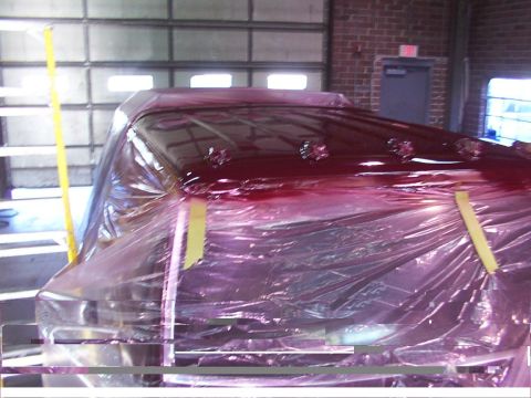 1988 Ford C-350 (Centurion Conversions) - Truck cab undergoing painting, covered in protective plastic sheeting.