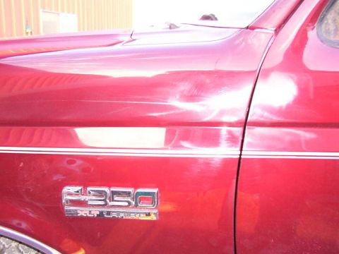 1988 Ford C-350 (Centurion Conversions) - Close-up of the side of a 1988 Ford C-350 XLT Lariat, showing the fender and door.