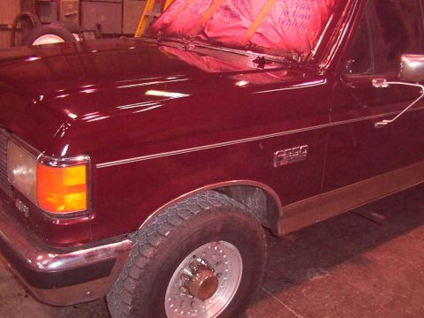 1988 Ford C-350 (Centurion Conversions) - Close-up of a maroon Ford F-Series truck's front quarter panel, showing the C350 badging.