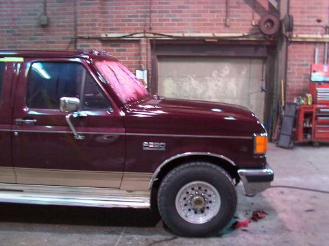 1988 Ford C-350 (Centurion Conversions) - Maroon van with tan trim, seen from the front three-quarter view. The badge on the fender reads C350.