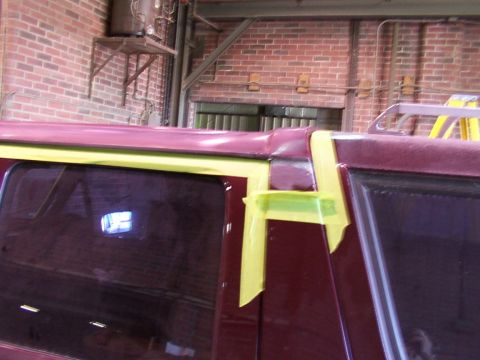 1988 Ford C-350 (Centurion Conversions) - Masking tape applied to the roofline and window frame of a vehicle.