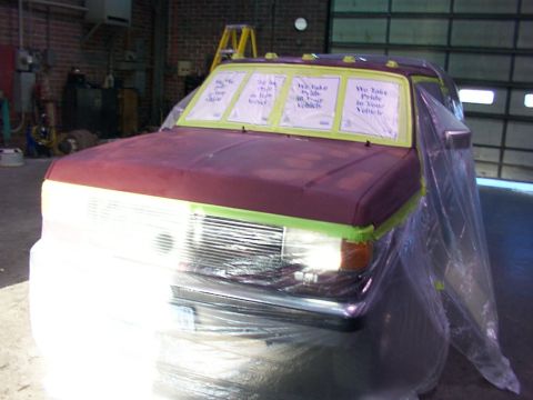 1988 Ford C-350 (Centurion Conversions) - A truck is being prepped for painting in a garage, with plastic sheeting covering most of the body.