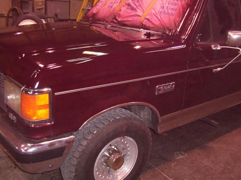 1988 Ford C-350 (Centurion Conversions) - Close-up of the front fender and hood of a 1988 Ford C-350 (Centurion Conversions) truck.