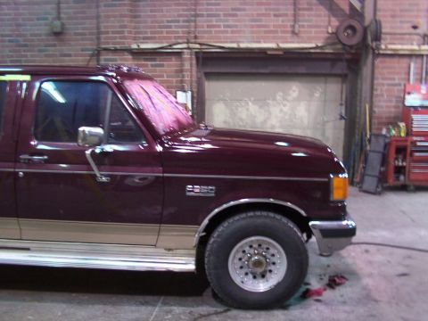 1988 Ford C-350 (Centurion Conversions) - This 1988 Ford C-350 (Centurion Conversions) is shown in a three-quarter front view, maroon paint, tan trim, and a pink tarp covering the r…