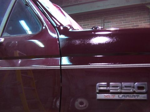 1988 Ford C-350 (Centurion Conversions) - Close-up of a maroon truck door showing the F-350 XLT LARIAT badging.