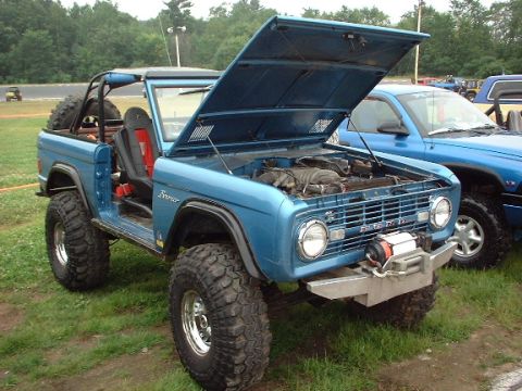 1978 Ford Bronco - A blue 1978 Ford Bronco is displayed with its hood open, revealing the engine and a front-mounted winch.