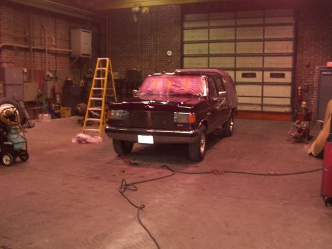 1988 Ford C-350 (Centurion Conversions) - Ford F-Series truck with front end covered in plastic, parked inside a garage.