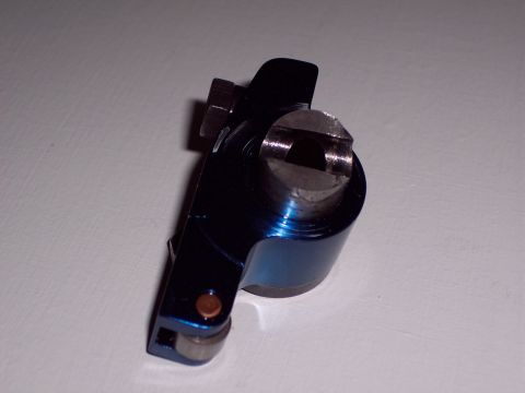 1963 Ford Galaxie - A close-up view of a blue metal rocker arm, a component of an engine.