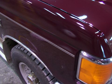 1988 Ford C-350 (Centurion Conversions) - Close-up of the front fender and headlight assembly on a 1988 Ford C-350 Centurion Conversions.