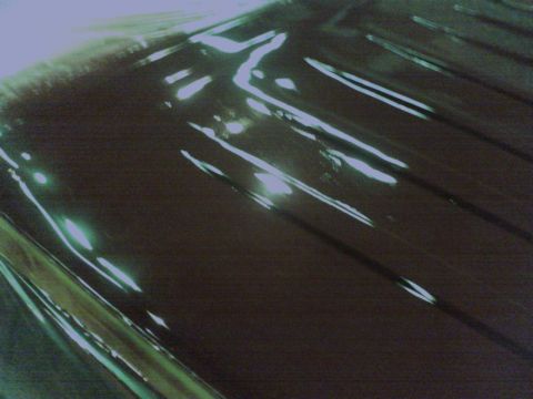 1988 Ford C-350 (Centurion Conversions) - Reflections on a dark, textured surface, details unclear.