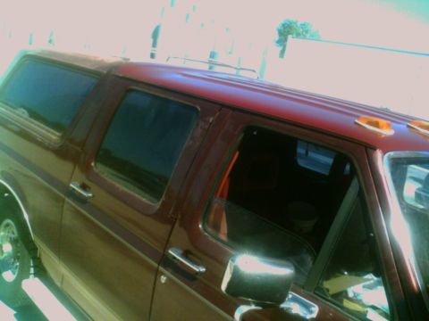 1988 Ford C-350 (Centurion Conversions) - This van features a two-tone paint scheme with a maroon body and a red roof, seen from the side.