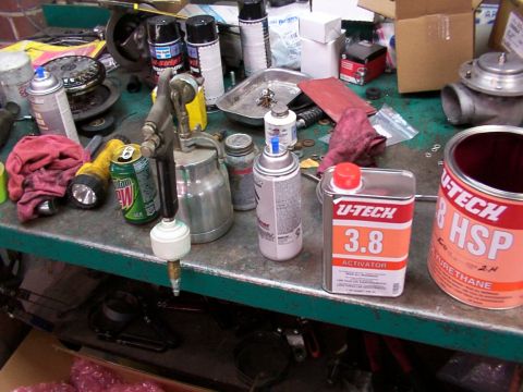 1988 Ford C-350 (Centurion Conversions) - Workbench setup with automotive paint supplies including spray cans, activator, and urethane.