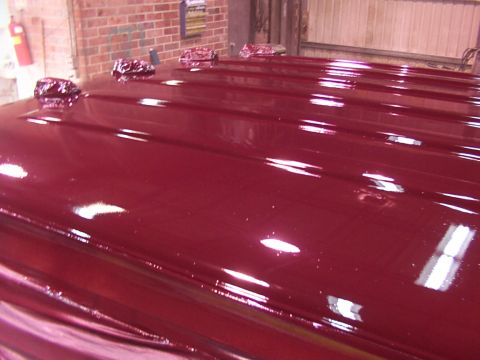 1988 Ford C-350 (Centurion Conversions) - Close-up of a glossy red vehicle roof, showing four lights mounted on top.