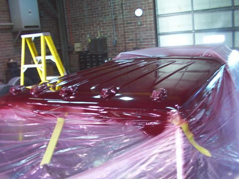 1988 Ford C-350 (Centurion Conversions) - Vehicle roof undergoing painting, covered in protective plastic sheeting and tape.