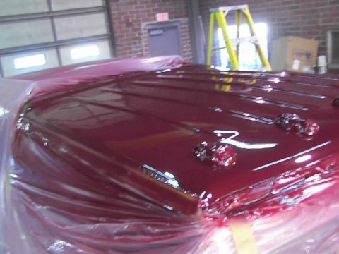 1988 Ford C-350 (Centurion Conversions) - Car hood covered in plastic wrap, likely after a fresh paint job.