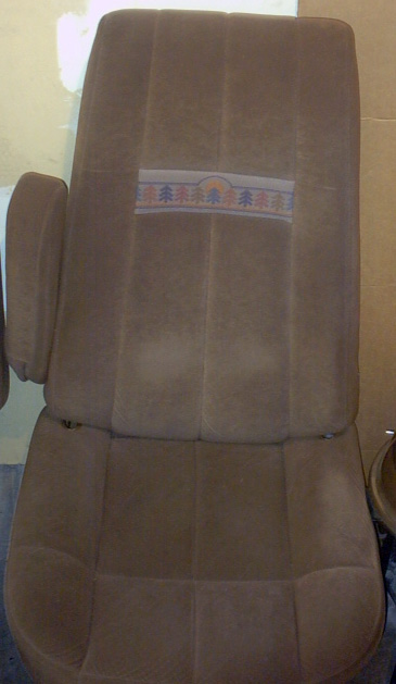 1989 Ford Bronco - A brown fabric car seat with a decorative stripe is shown.