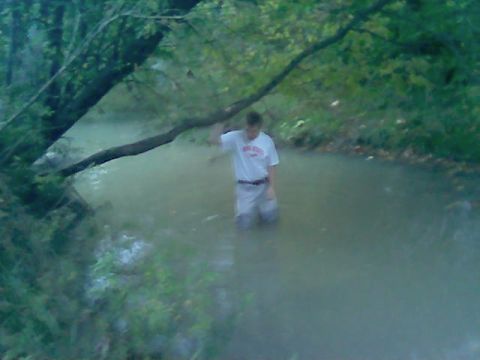 1997 Ford Probe - A person wades through a shallow stream surrounded by trees. A watermark for SUPERMOTORS is visible in the lower right corner.