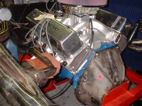 1969 Ford Mustang - Close-up view of an engine with chrome valve covers and exhaust headers.