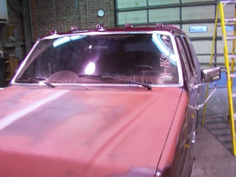 1988 Ford C-350 (Centurion Conversions) - Front view of a red truck with visible text on the windshield and chrome trim.