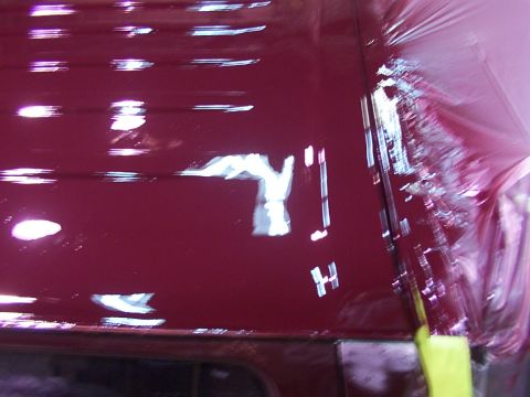 1988 Ford C-350 (Centurion Conversions) - The reflection on the maroon roof shows some white shapes and the letter H.